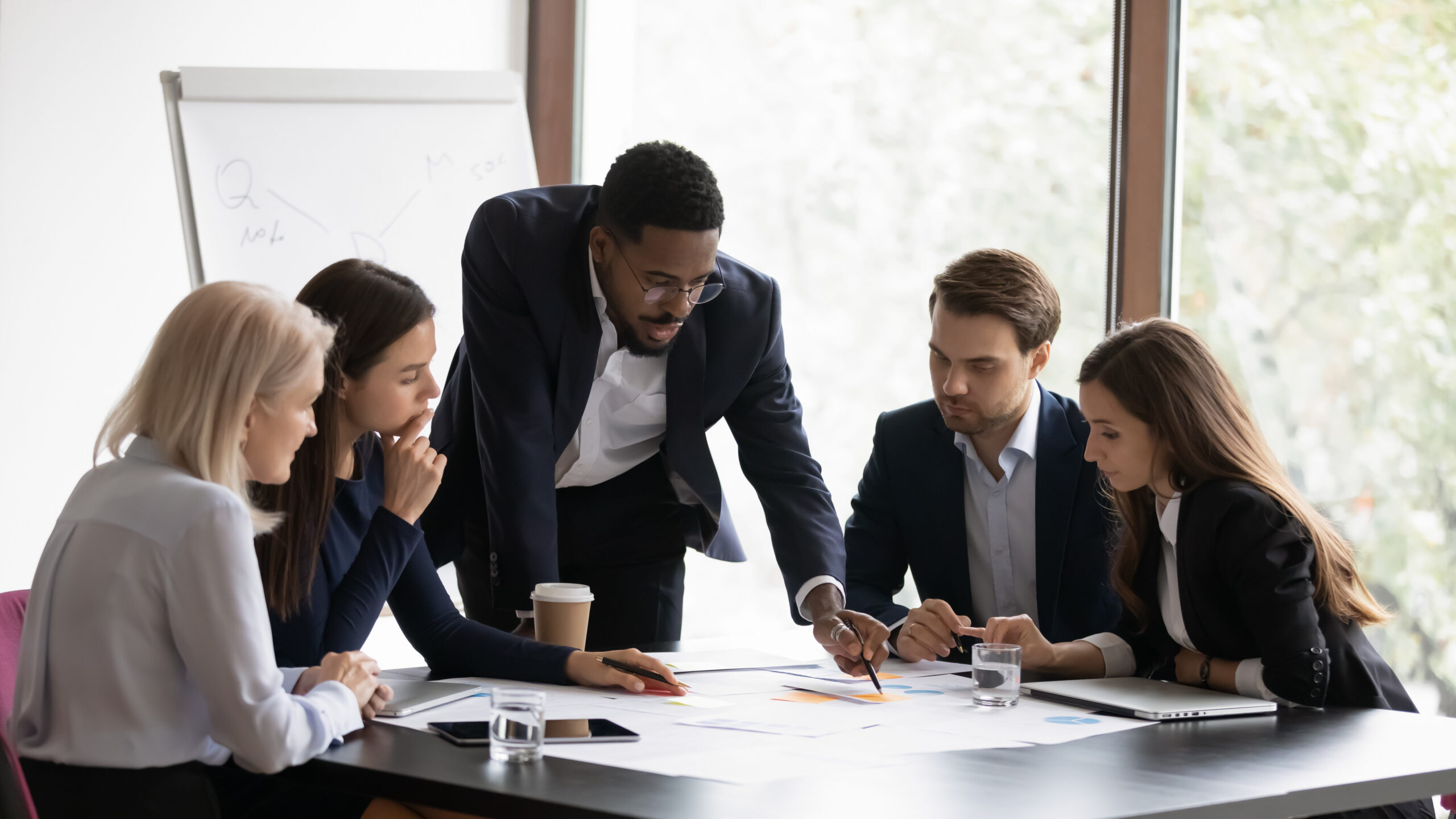 Confident biracial businessman head meeting with diverse colleagues